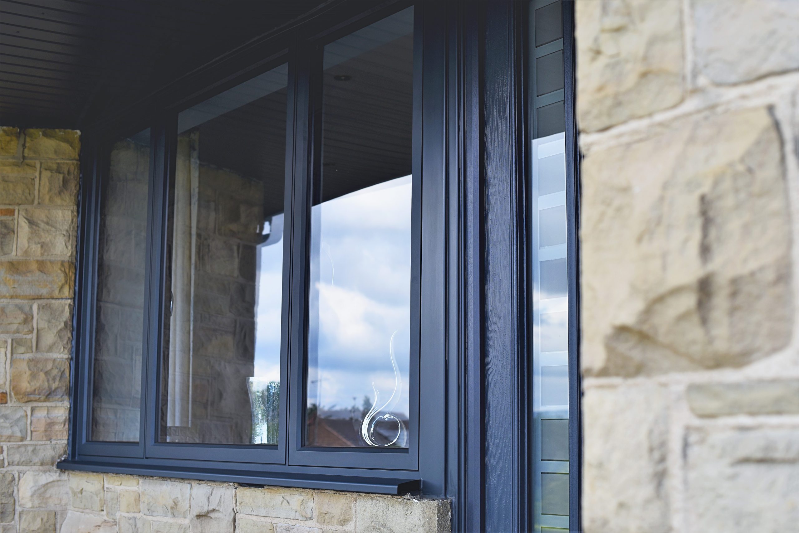 Quickslide provides a custom window for Wendy’s triangular kitchen diner, using sleek aluminium frames to boost light