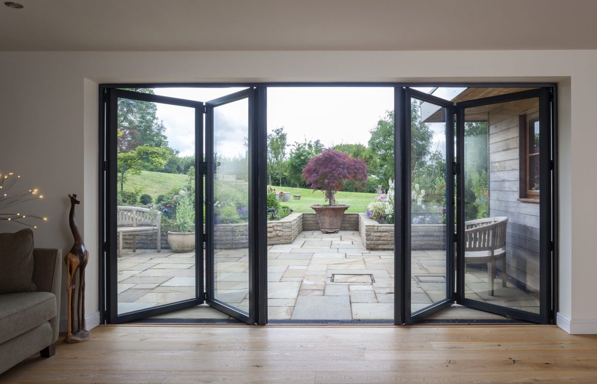 Modern interior with Quickslide's sleek bifold doors, seamlessly connecting indoor and outdoor spaces.