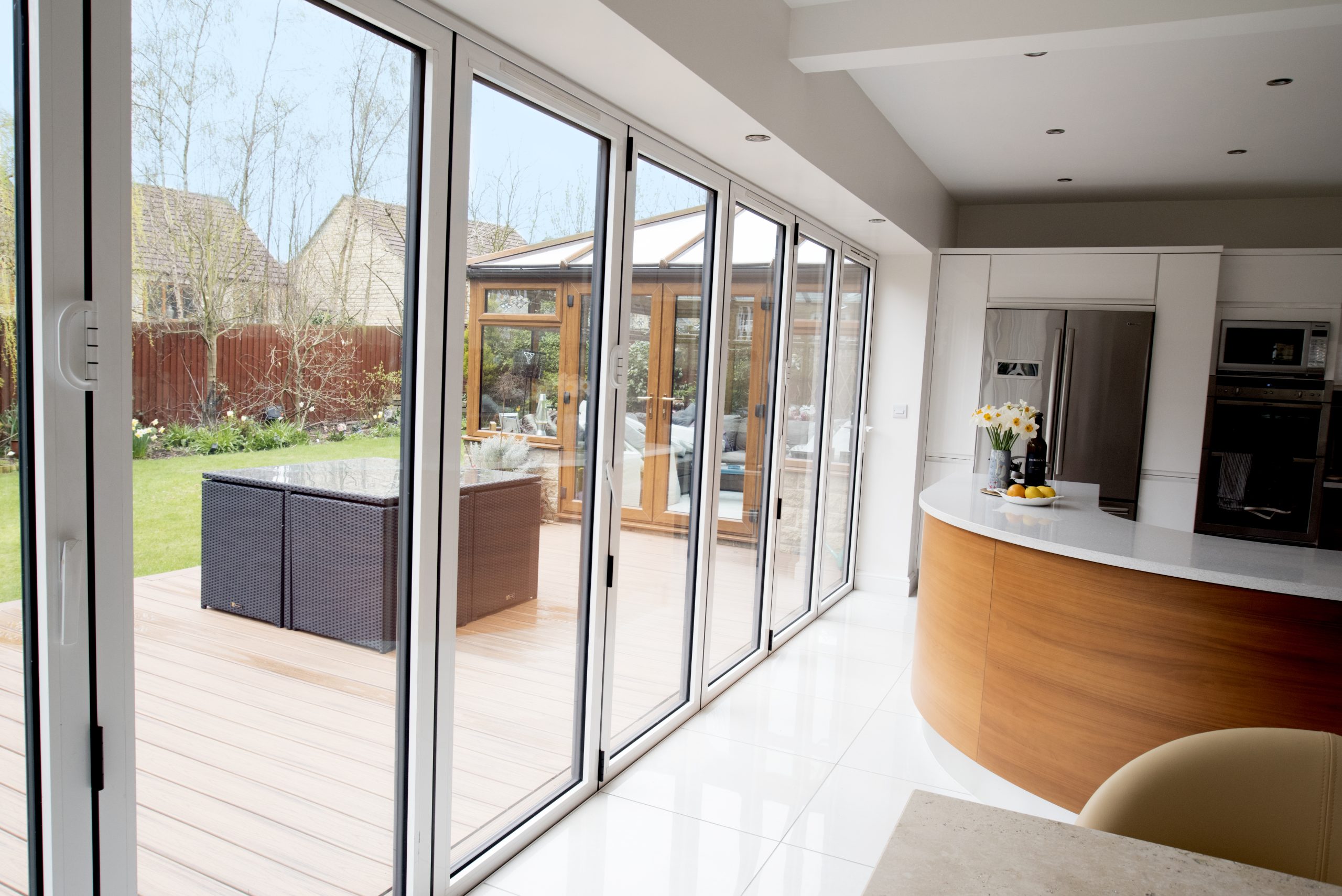 Aluminium bifold doors fully opened to connect indoor and outdoor living areas seamlessly