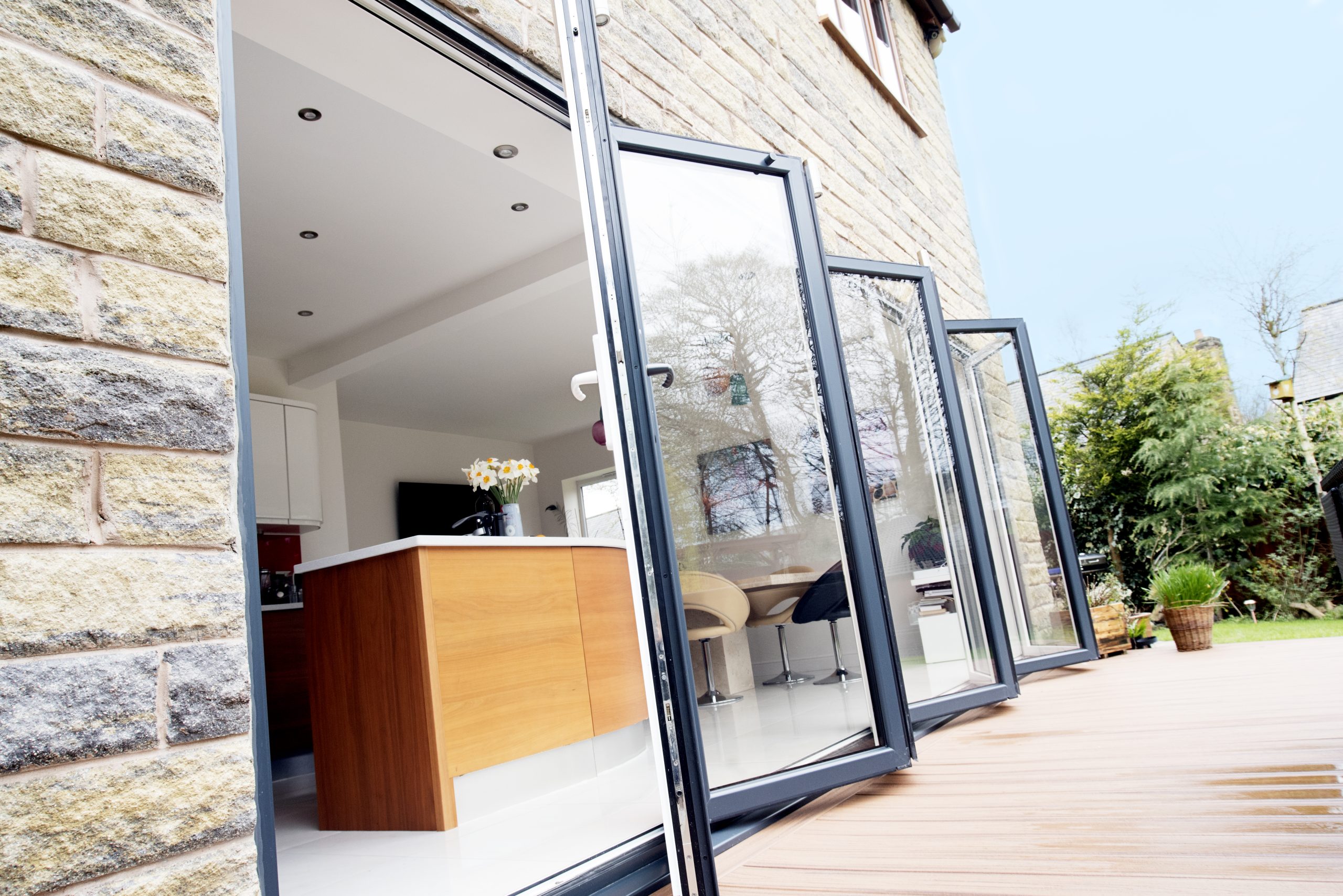 Slim aluminium bifold door frame with double glazing.