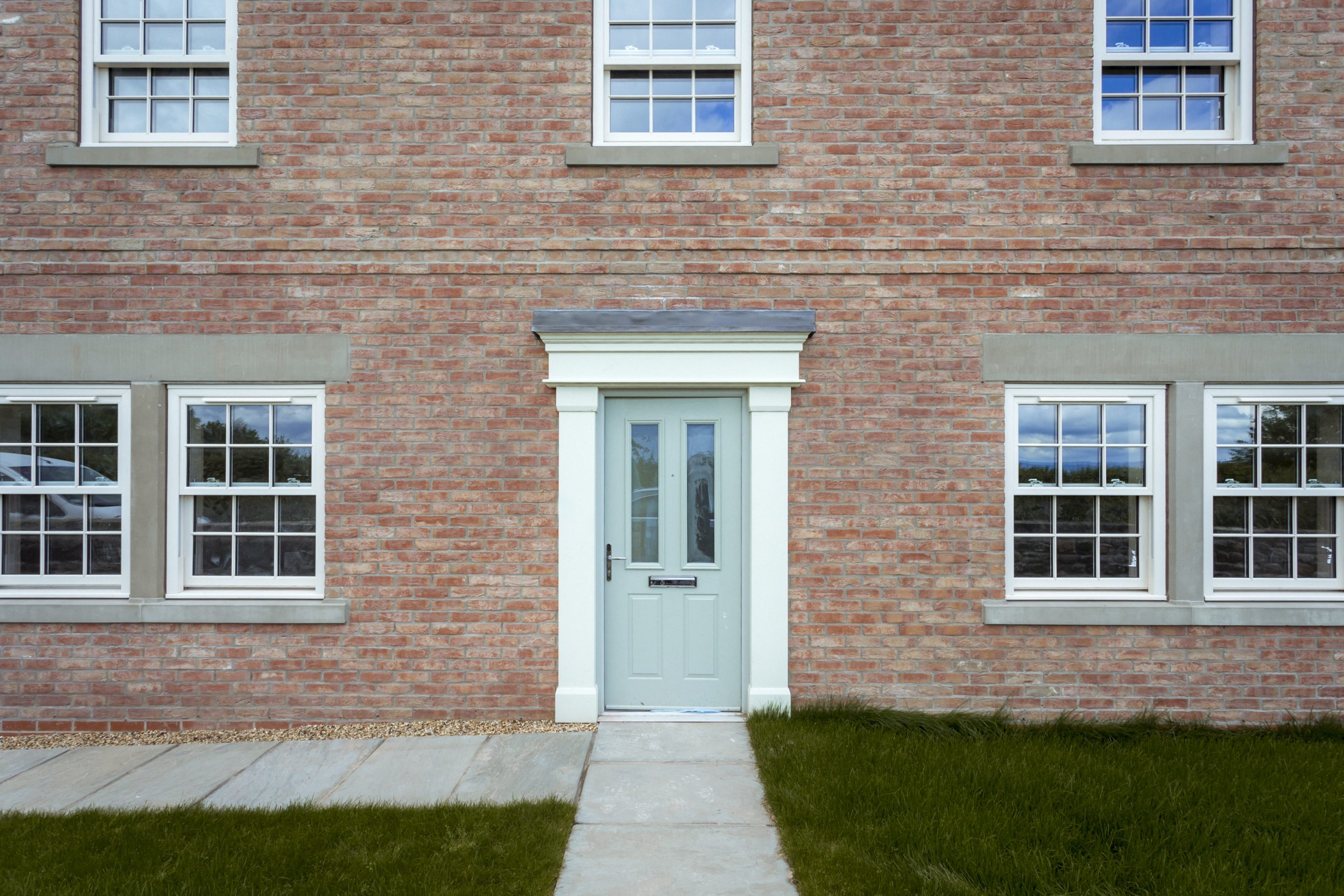 Luxurious Palladian Homes feature traditionally styled windows, adding timeless charm to upscale living spaces.