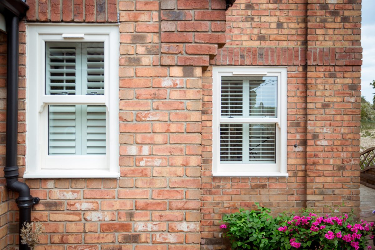 Sealing gaps on a uPVC sash window to prevent draughts and improve insulation.