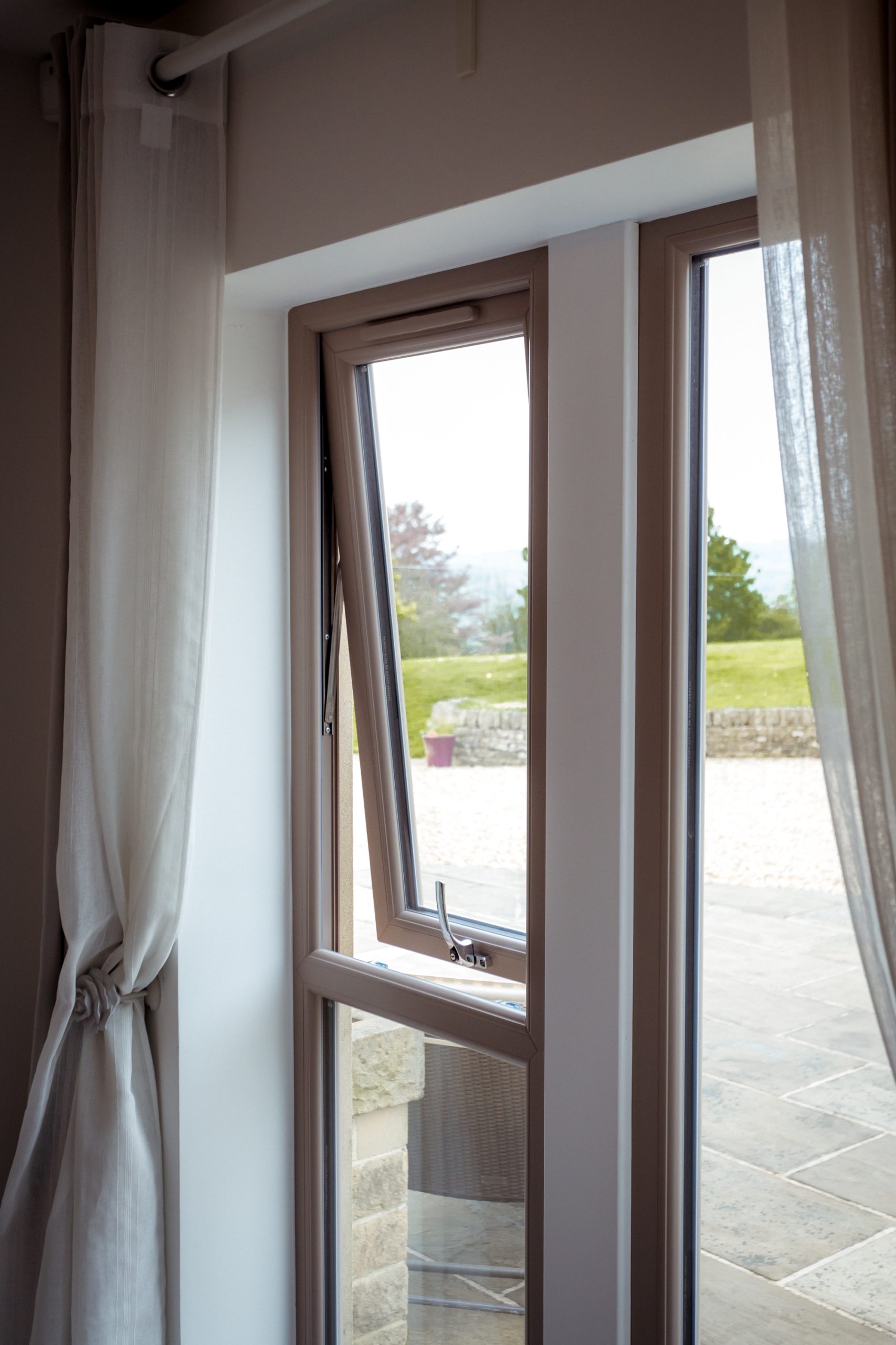 Top-hung uPVC casement window partially open