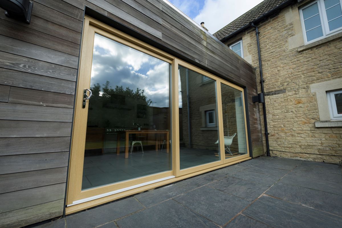 Modern sliding patio doors with large glass panels, providing a seamless indoor-outdoor connection and natural light