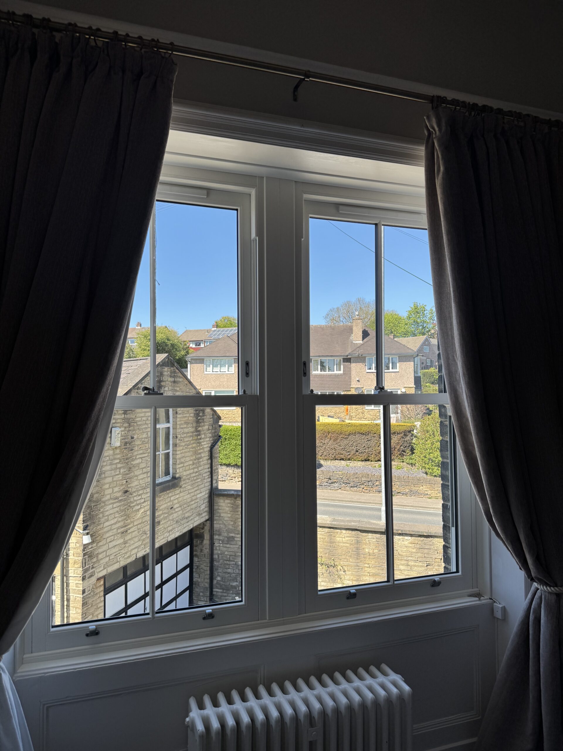 Interior view of white uPVC sliding sash window with slim midrail