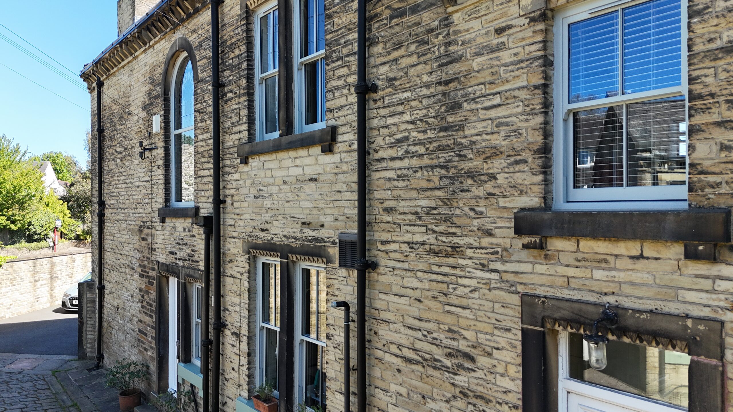 uPVC sliding sash windows fitted across a traditional stone house
